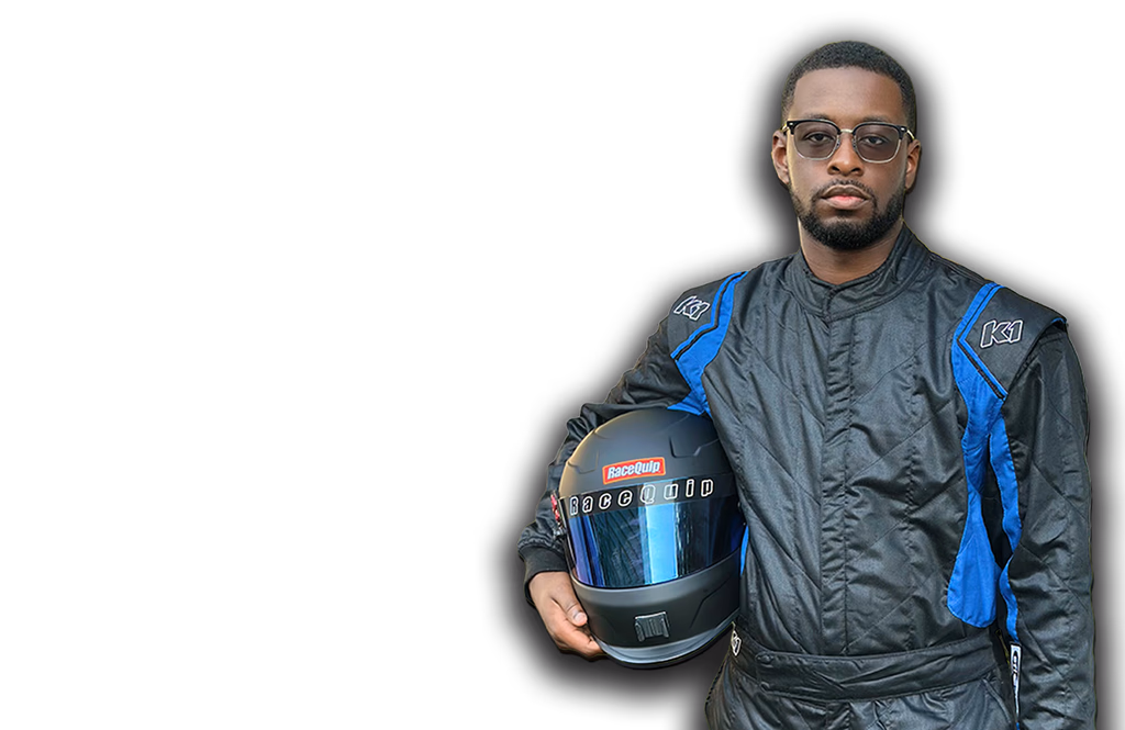 Jay Taylor in his racing suit holding a helmet